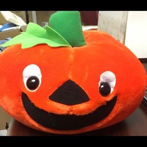 Plush orange jack o lantern smiling for Halloween